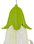 Decorative light with green top and white base on a white background