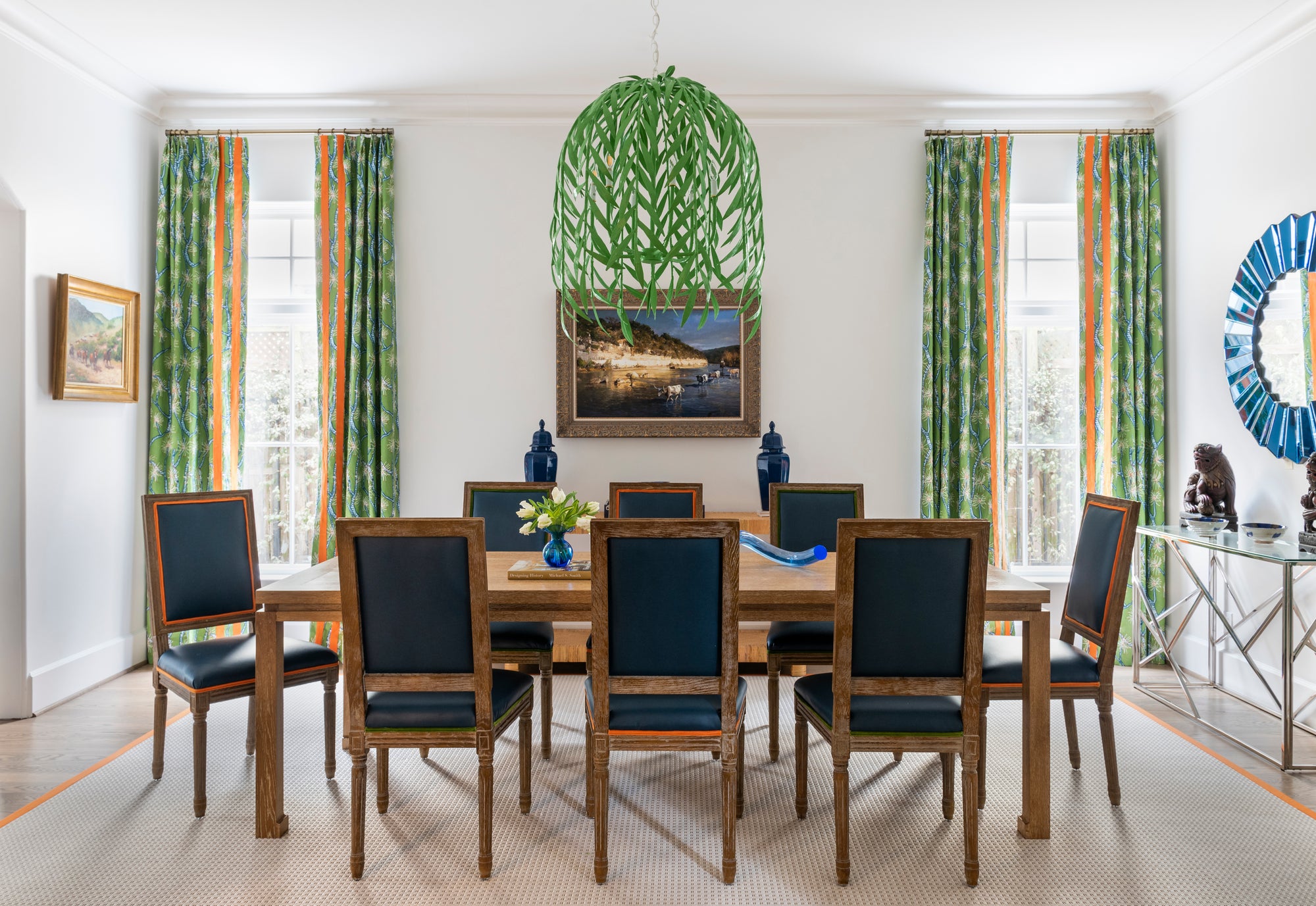 Nature inspired ceiling light for dining room. Green Willow chandelier in a minimal dining room with green and navy color color palette. 